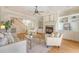 Bright living room featuring a fireplace, built-in shelving, a ceiling fan, and access to the staircase at 3331 Cottonfield Dr, Mount Pleasant, SC 29466