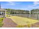 Backyard featuring a wooden fence, green lawn, and views of a forest beyond at 3529 Habenaria Rd # 33, Mount Pleasant, SC 29466