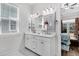 Bright bathroom with a double sink vanity, white cabinets, and a window at 3529 Habenaria Rd # 33, Mount Pleasant, SC 29466