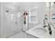 Bright bathroom with a glass shower, white cabinets, and a flamingo decoration at 3529 Habenaria Rd # 33, Mount Pleasant, SC 29466