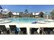 Stunning community pool with lounge chairs, sun umbrellas, and a playful splash fountain for Gathering fun and relaxation at 3529 Habenaria Rd # 33, Mount Pleasant, SC 29466