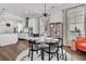 Bright dining area with hardwood floors, a modern chandelier, and a view into the stylish, well-equipped kitchen at 3529 Habenaria Rd # 33, Mount Pleasant, SC 29466