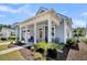 Charming single-story home showing a welcoming covered front porch with nice landscaping and a side entry garage at 3529 Habenaria Rd # 33, Mount Pleasant, SC 29466