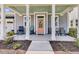 A welcoming front porch of a single-story home features comfortable seating and tasteful landscaping at 3529 Habenaria Rd # 33, Mount Pleasant, SC 29466