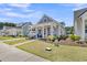 Charming home with a landscaped front yard and inviting covered porch with seating at 3529 Habenaria Rd # 33, Mount Pleasant, SC 29466