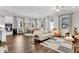 Bright living room with hardwood floors, white sofa, ceiling fan, and ample natural light from multiple windows at 3529 Habenaria Rd # 33, Mount Pleasant, SC 29466