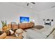 Cozy living room showcasing a modern entertainment center and comfortable seating with hardwood floors and light walls at 3529 Habenaria Rd # 33, Mount Pleasant, SC 29466