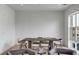 Neutral-toned dining room features a wooden table, cushioned chairs, and view to the outdoors at 405 Spartina Ln # 405, Charleston, SC 29492