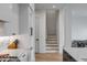 Bright hallway view to the stairwell and dining area, featuring hardwood floors at 405 Spartina Ln # 405, Charleston, SC 29492