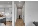 The hallway leads to a modern kitchen and dining area, with hardwood flooring and recessed lighting at 405 Spartina Ln # 405, Charleston, SC 29492