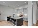 Modern kitchen with sleek white cabinets, an island with seating, and stainless steel appliances at 405 Spartina Ln # 405, Charleston, SC 29492