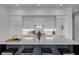 Modern kitchen with white cabinets, waterfall island, breakfast bar, and stainless steel appliances at 405 Spartina Ln # 405, Charleston, SC 29492