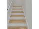 Bright and airy stairway with hardwood treads and white risers, leading to the upper level at 405 Spartina Ln # 405, Charleston, SC 29492