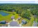 Aerial community view showing well-maintained lawns, a pond, and homes in a private cul-de-sac surrounded by trees at 407 Spruce Ivy St, Moncks Corner, SC 29461