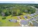 Aerial view shows a community with large, green lawns, trees, and a peaceful, natural setting at 407 Spruce Ivy St, Moncks Corner, SC 29461