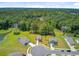 Community aerial view showcases beautiful homes, green lawns, and a nearby pond, all surrounded by dense woodlands at 407 Spruce Ivy St, Moncks Corner, SC 29461