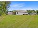 Wide shot of the home's exterior and backyard featuring lush green grass at 407 Spruce Ivy St, Moncks Corner, SC 29461
