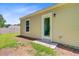 Backyard featuring a door to enter the property and a manicured lawn at 407 Spruce Ivy St, Moncks Corner, SC 29461