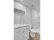 Bright bathroom with white vanity, sink, toilet, and walk-in shower featuring shelving at 407 Spruce Ivy St, Moncks Corner, SC 29461