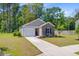 Inviting single-story home with brick accents, lush lawn, and charming curb appeal at 407 Spruce Ivy St, Moncks Corner, SC 29461