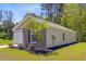 A side view of a well-maintained single-story home with brick accents and a manicured lawn at 407 Spruce Ivy St, Moncks Corner, SC 29461