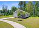 Side view of a well-kept single-story home surrounded by lush trees and a landscaped yard at 407 Spruce Ivy St, Moncks Corner, SC 29461