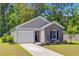 Charming single-story home with a manicured lawn and inviting entrance, showcasing curb appeal at 407 Spruce Ivy St, Moncks Corner, SC 29461