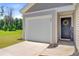 Welcoming front exterior with a one-car garage, neat landscaping, and a charming entryway with a wreath at 407 Spruce Ivy St, Moncks Corner, SC 29461