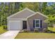 Charming single-story home with brick accents, a well-manicured lawn, and an inviting entrance at 407 Spruce Ivy St, Moncks Corner, SC 29461