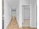 A bright hallway with wood-look floors leading to various rooms within the home at 407 Spruce Ivy St, Moncks Corner, SC 29461