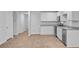 Modern kitchen featuring white cabinets and stainless-steel appliances and light wood floors at 407 Spruce Ivy St, Moncks Corner, SC 29461