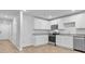 Modern kitchen features white cabinetry, stainless steel appliances, and wood-look floors at 407 Spruce Ivy St, Moncks Corner, SC 29461