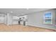 Open-concept kitchen features stainless appliances and light-filled connected living space at 407 Spruce Ivy St, Moncks Corner, SC 29461