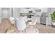 Bright kitchen features stainless appliances, white cabinets, and a cozy dining area at 407 Spruce Ivy St, Moncks Corner, SC 29461