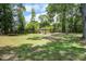 Expansive backyard with a gazebo, mature trees, and lush green grass at 408 N Palmetto St, Summerville, SC 29483