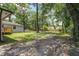 Large backyard featuring mature trees, a gazebo, and a gravel path at 408 N Palmetto St, Summerville, SC 29483