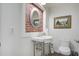 Small bathroom with a decorative mirror and vintage style sink and toilet at 408 N Palmetto St, Summerville, SC 29483