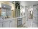 Bright bathroom featuring double vanity sinks, marble countertops, and updated fixtures at 408 N Palmetto St, Summerville, SC 29483