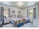 Charming bedroom with matching twin beds, complemented by whimsical decor and plenty of natural light at 408 N Palmetto St, Summerville, SC 29483