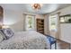 This bedroom features two windows, hardwood floors, and brick accent wall at 408 N Palmetto St, Summerville, SC 29483