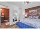 This bedroom features a brick accent wall, hardwood floors, and view of the bathroom at 408 N Palmetto St, Summerville, SC 29483