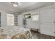 This bedroom features a sliding bathroom door, white walls, and modern chandelier at 408 N Palmetto St, Summerville, SC 29483