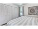 Well-lit bedroom featuring a white striped bed, an abundance of storage, and a peaceful ambiance at 408 N Palmetto St, Summerville, SC 29483