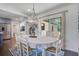 Dining room with white table and chairs, modern light fixture and view to backyard at 408 N Palmetto St, Summerville, SC 29483