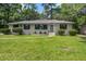 Well-maintained brick home with a spacious lawn, beautiful landscaping, and classic architectural design at 408 N Palmetto St, Summerville, SC 29483