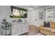 Foyer with stylish decor, featuring hardwood floors, white trim, and abundant natural light streaming through the windows at 408 N Palmetto St, Summerville, SC 29483