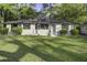 Inviting front exterior of a charming brick home with well-maintained lawn and mature shrubbery at 408 N Palmetto St, Summerville, SC 29483
