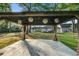 Gazebo features hanging lights and curtains, creating a cozy outdoor retreat within a lush, green landscape at 408 N Palmetto St, Summerville, SC 29483