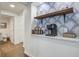 Chic hallway with a coffee bar, and a beautifully patterned accent wall at 408 N Palmetto St, Summerville, SC 29483