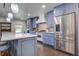 Modern kitchen featuring stainless steel appliances, a large island with a marble countertop, and custom cabinets at 408 N Palmetto St, Summerville, SC 29483